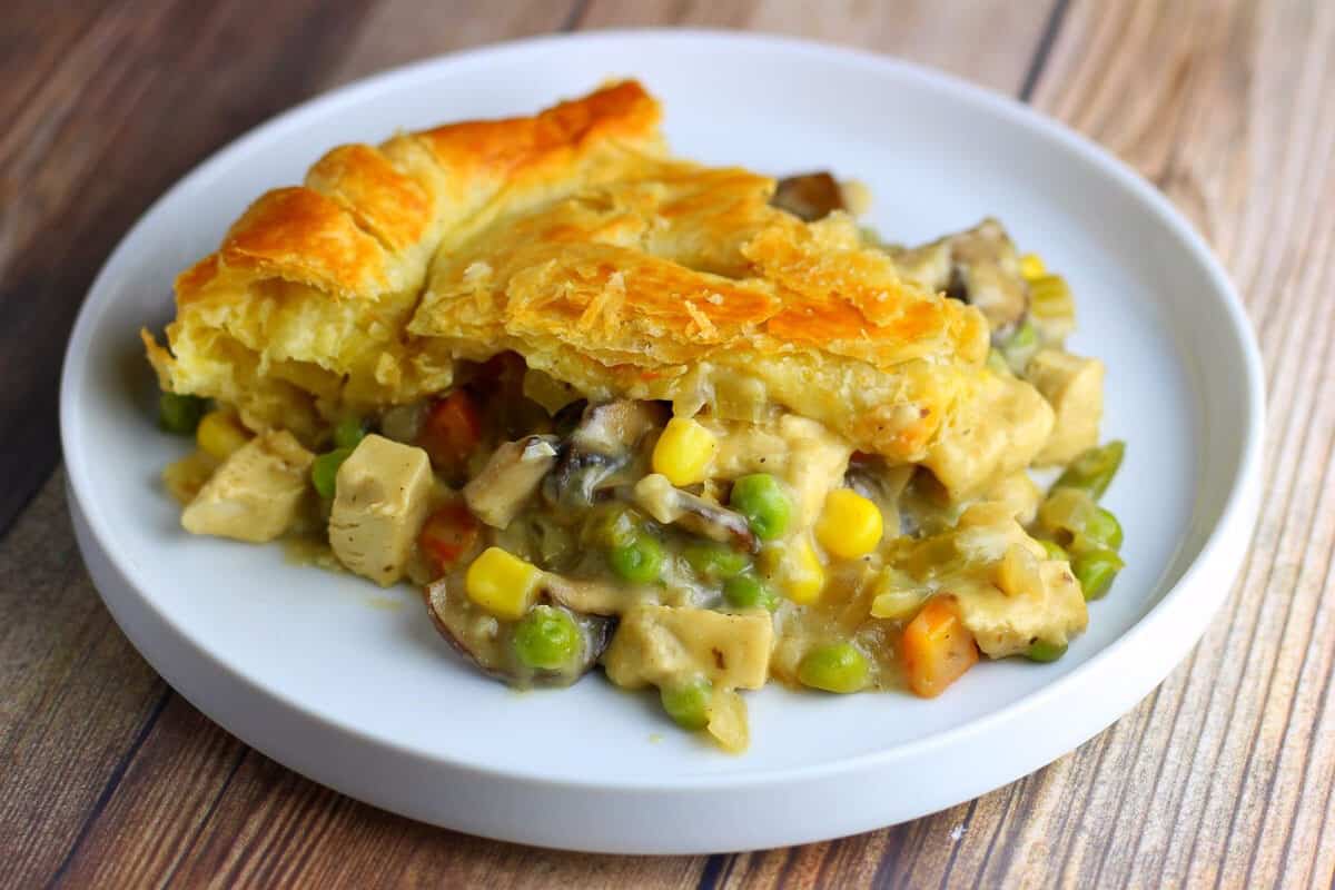 slice of vegan chicken pot pie with puff pastry topping