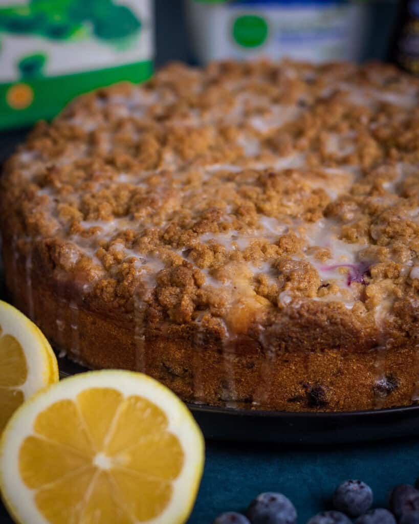 closeup image of blueberry coffee cake to show the texture of the iced crumble topping