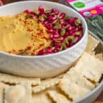 Rosemary crackers on a plate with hummus