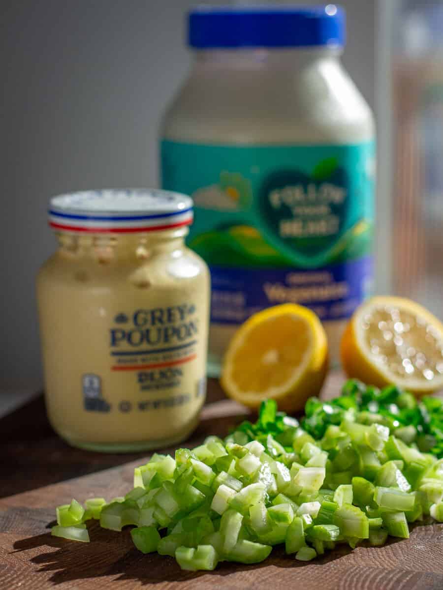ingredients for chickpea tuna salad: celery, scallions, lemon, vegan mayo, and dijon mustard