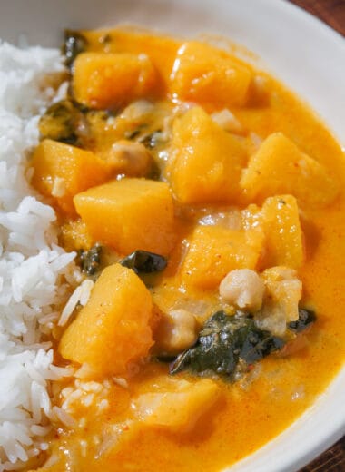 closeup shot of butternut squash curry in a bowl with steamed white rice