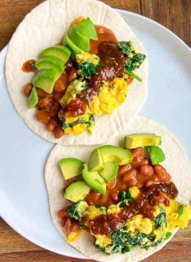 two high-protein vegan breakfast tacos on a plate with salsa