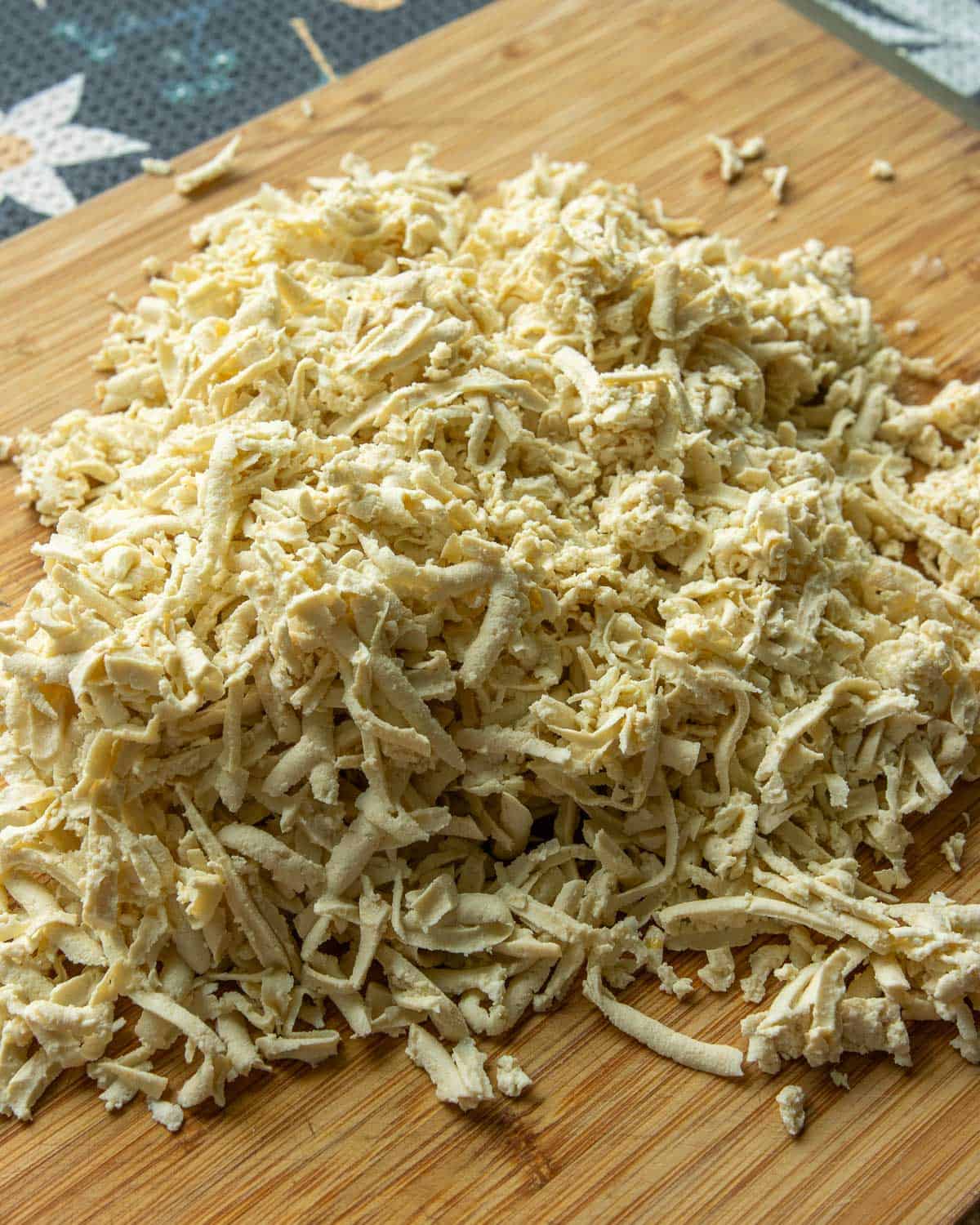 A pile of tofu shredded using a cheese grater.