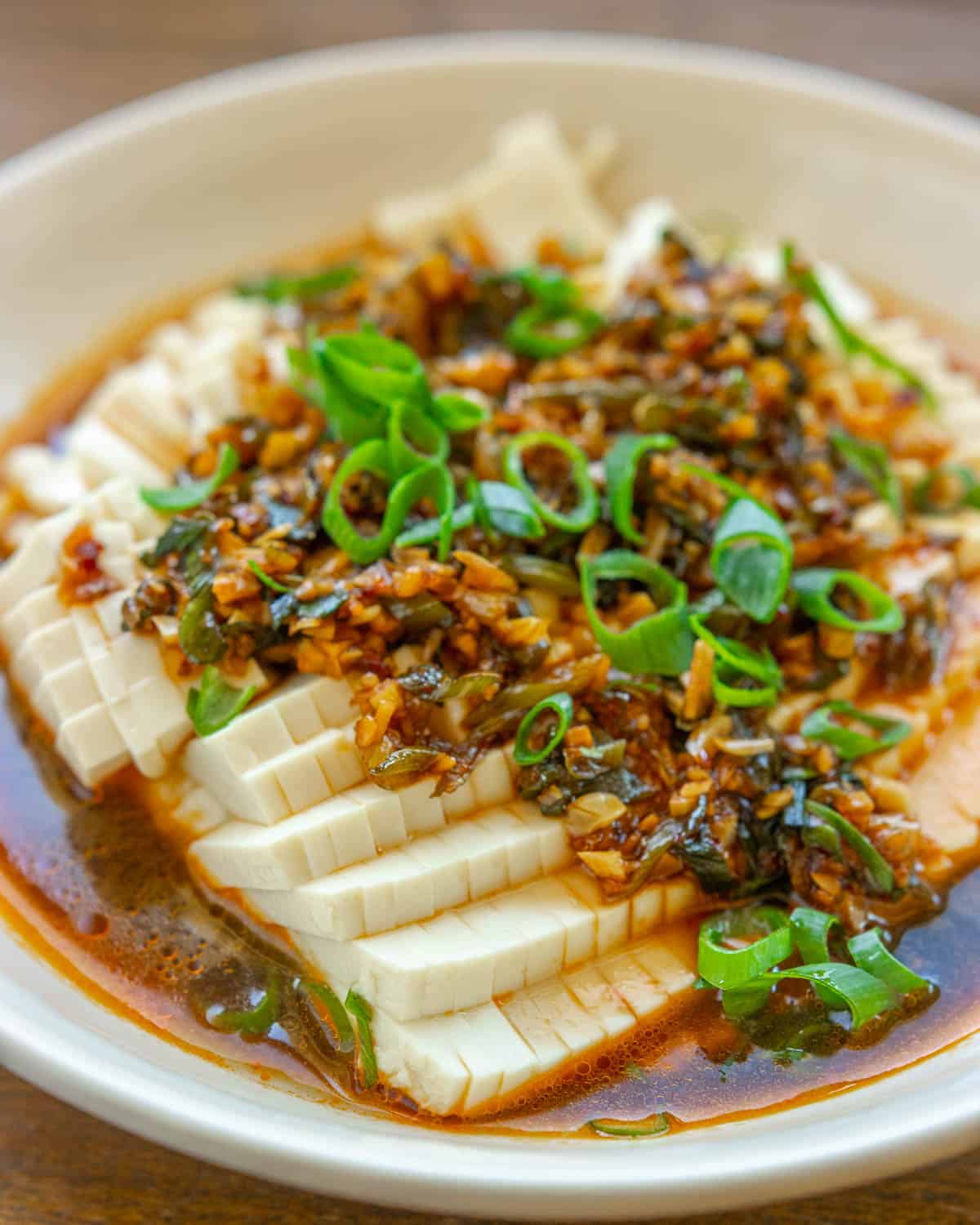silken tofu topped with chili garlic sauce and fresh sliced scallions